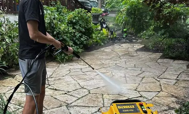 Power washing a stone patio