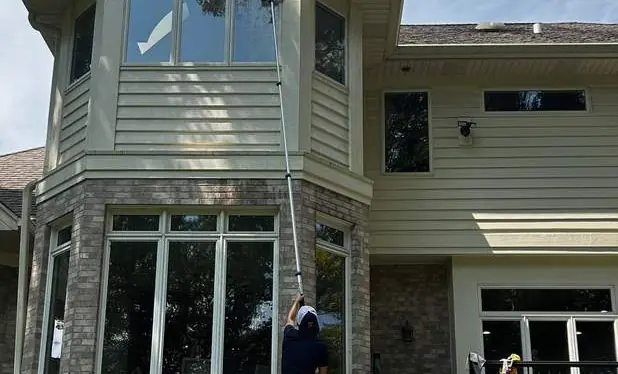 Window washing on a tall North Shore home